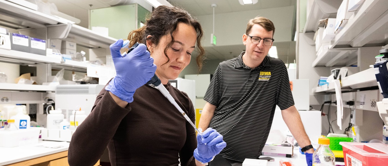 A professor supervising a student in the lab